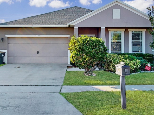 view of front of home featuring a garage and a front yard