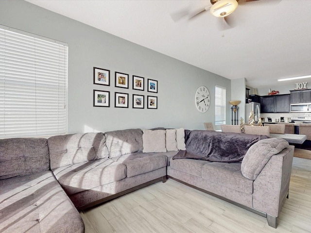 living room with hardwood / wood-style floors and ceiling fan