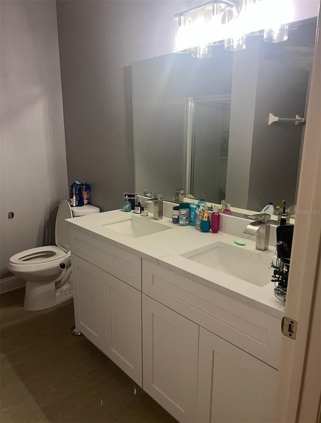 bathroom featuring hardwood / wood-style flooring, vanity, and toilet