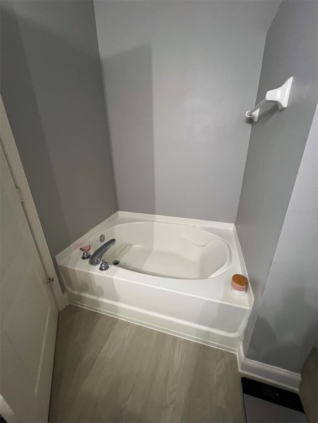 bathroom featuring a tub and hardwood / wood-style floors