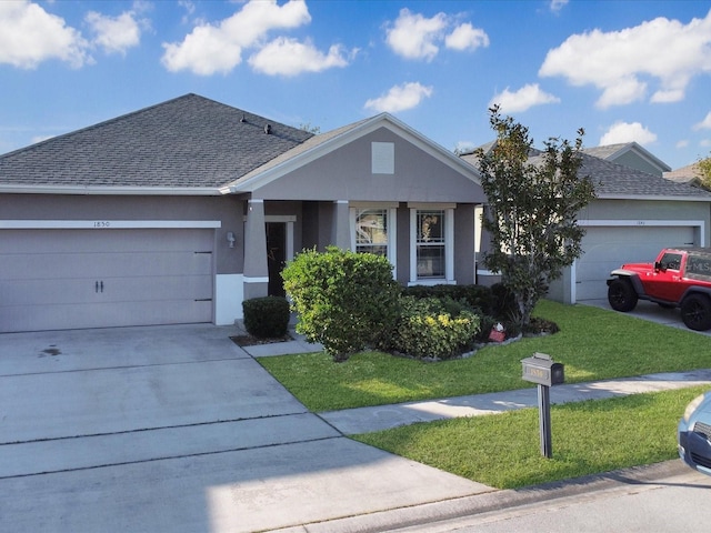 view of front of property featuring a garage and a front lawn