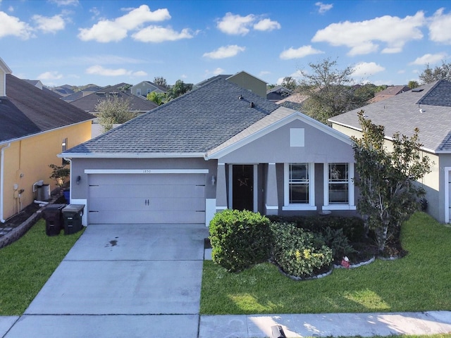 ranch-style house with a garage and a front yard