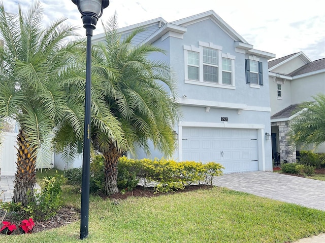 view of front of property with a front lawn and a garage