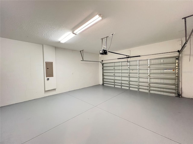 garage featuring electric panel and a garage door opener