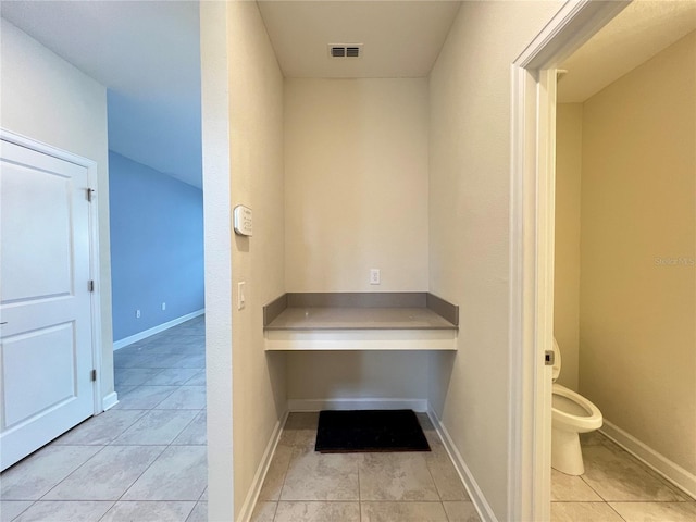 bathroom with tile patterned floors and toilet