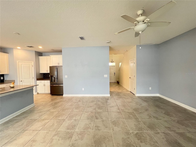 kitchen with white cabinetry, stainless steel fridge with ice dispenser, ceiling fan, and light tile patterned floors