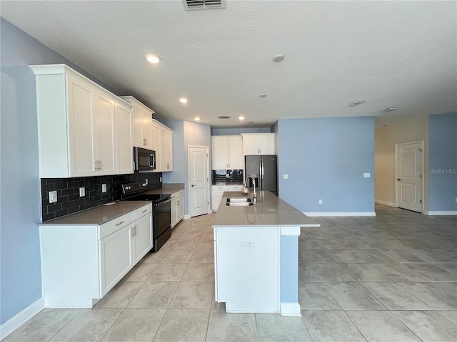 kitchen with black electric range oven, sink, an island with sink, white cabinetry, and stainless steel fridge with ice dispenser