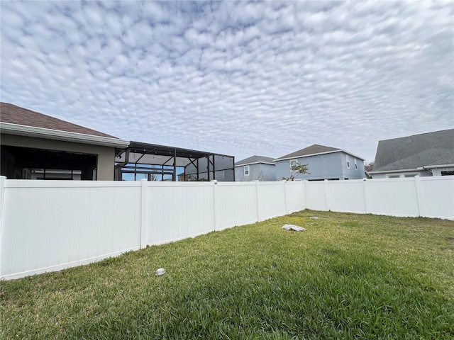 view of yard featuring glass enclosure