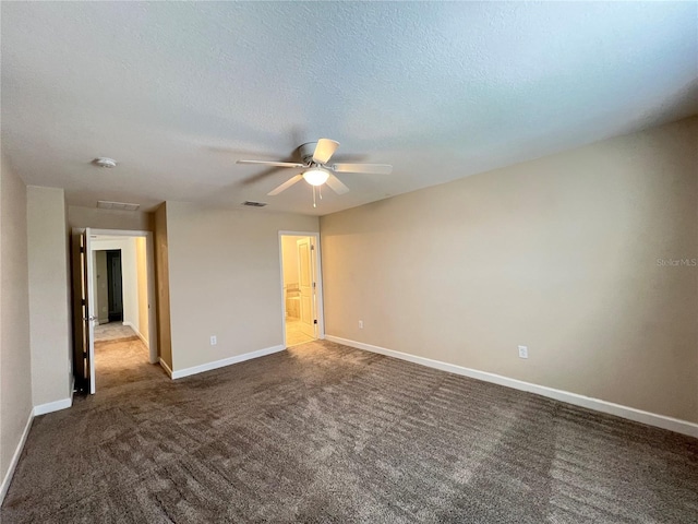 carpeted spare room with ceiling fan and a textured ceiling