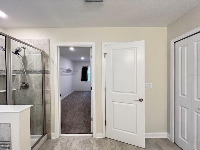 bathroom featuring tile patterned flooring and walk in shower