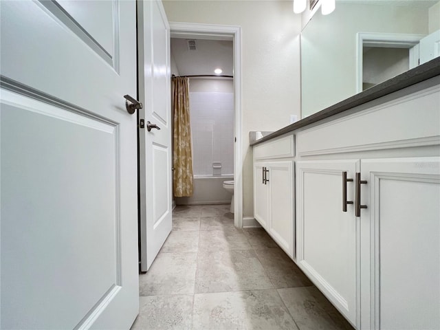 bathroom with shower / bath combo and toilet