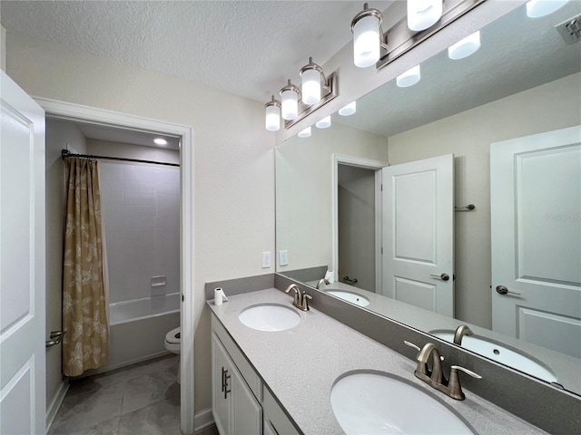 full bathroom with vanity, tile patterned flooring, toilet, a textured ceiling, and shower / tub combo