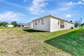 view of side of property featuring a yard