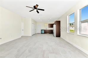 unfurnished living room with ceiling fan