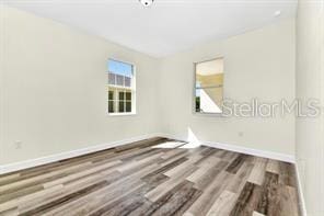 spare room featuring hardwood / wood-style floors