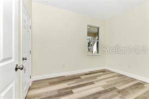 spare room with hardwood / wood-style flooring