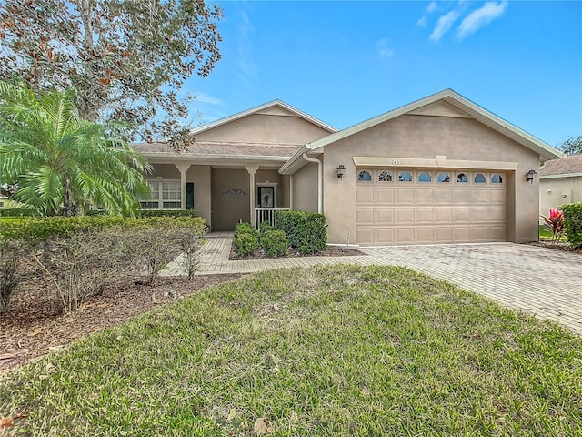 ranch-style home with a front yard and a garage