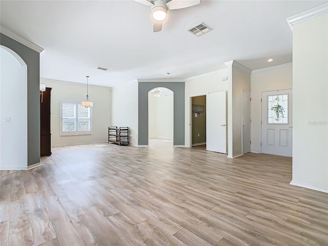 unfurnished living room featuring a wealth of natural light, ceiling fan, light hardwood / wood-style floors, and ornamental molding