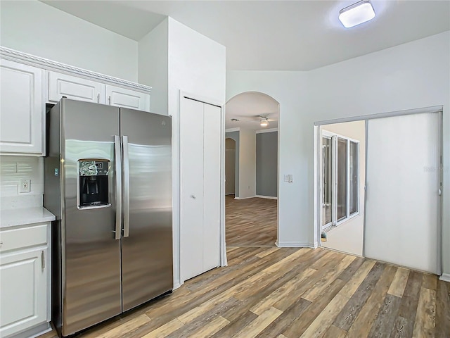 kitchen with white cabinetry, stainless steel fridge with ice dispenser, light hardwood / wood-style flooring, and ceiling fan