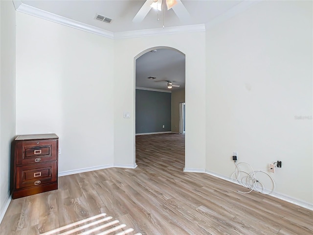 spare room with ceiling fan, crown molding, and light hardwood / wood-style floors