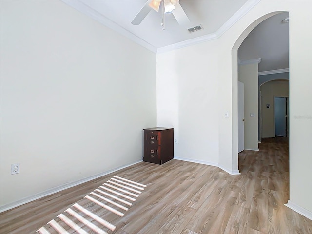 spare room featuring light hardwood / wood-style floors, ceiling fan, and crown molding