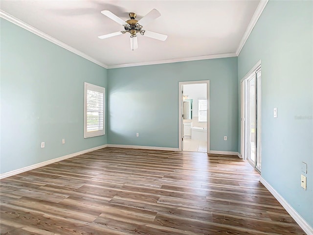 spare room with ceiling fan, crown molding, and dark wood-type flooring