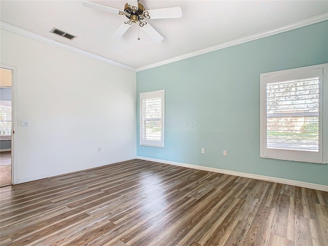 empty room featuring ceiling fan, dark hardwood / wood-style flooring, and ornamental molding