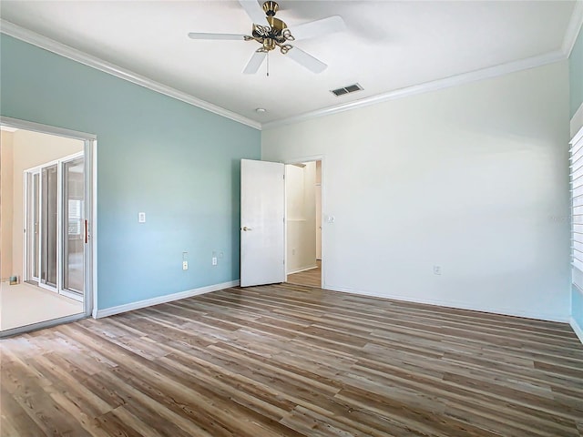 spare room with ceiling fan, dark hardwood / wood-style flooring, and ornamental molding