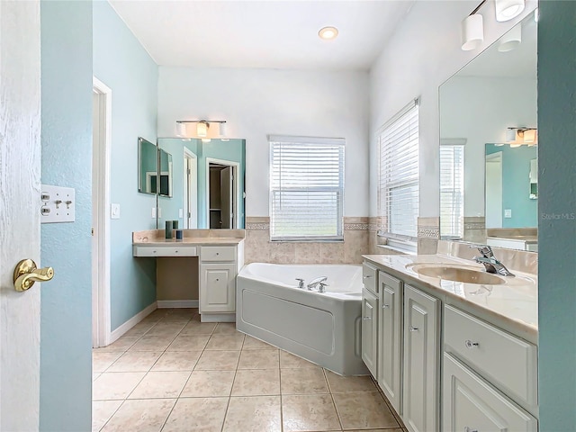 bathroom with a bath, vanity, and tile patterned floors