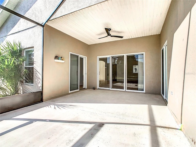 unfurnished sunroom featuring ceiling fan