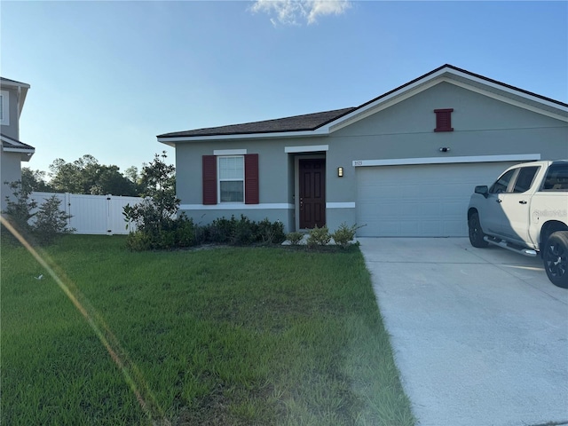 single story home with a garage and a front lawn