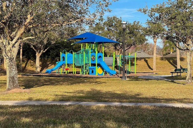 view of playground with a lawn