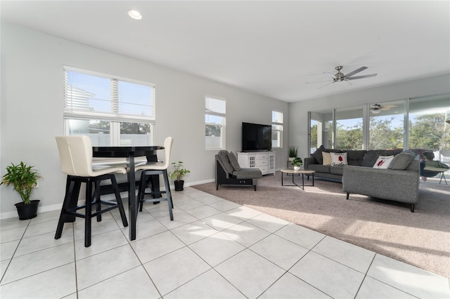 living room with ceiling fan and light colored carpet