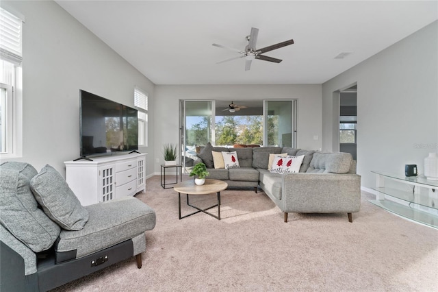 living room featuring ceiling fan, a healthy amount of sunlight, and carpet flooring