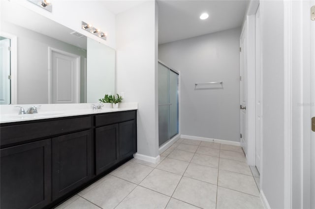 bathroom with walk in shower, tile patterned floors, and vanity