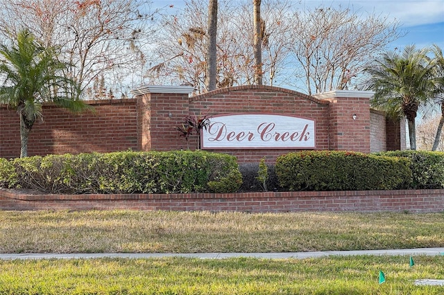 community / neighborhood sign with a lawn