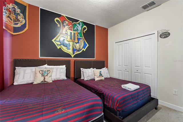 bedroom with carpet flooring, a textured ceiling, and a closet