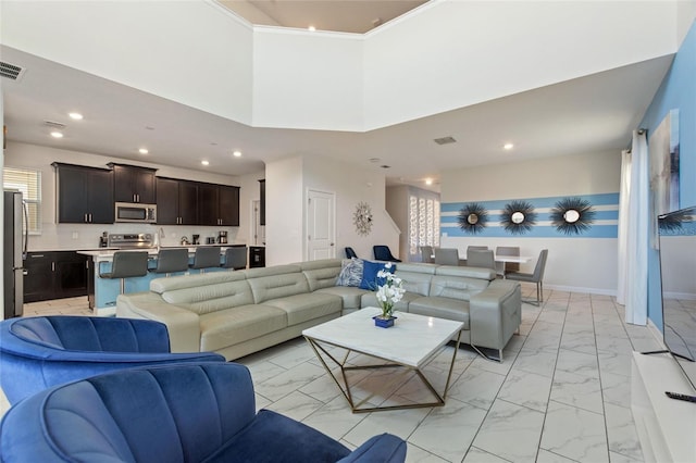 living room featuring a high ceiling