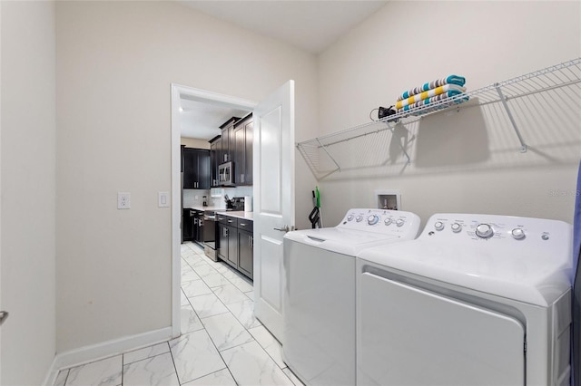 clothes washing area with washer and clothes dryer