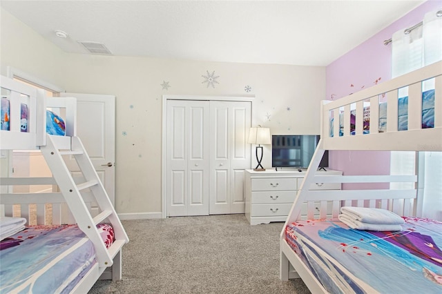 bedroom featuring light carpet and a closet