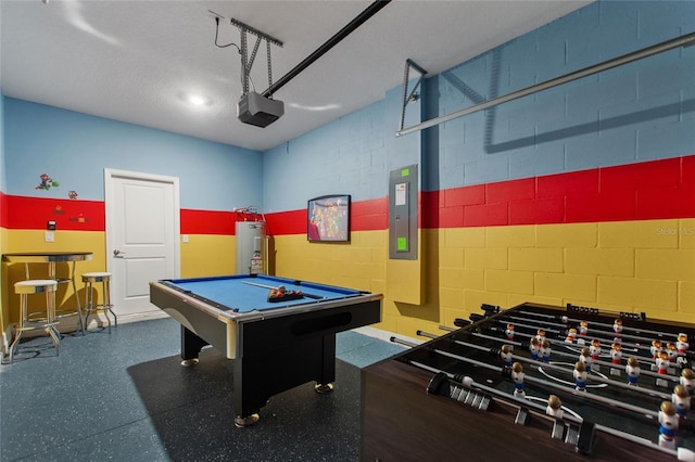 recreation room with electric panel, water heater, and billiards