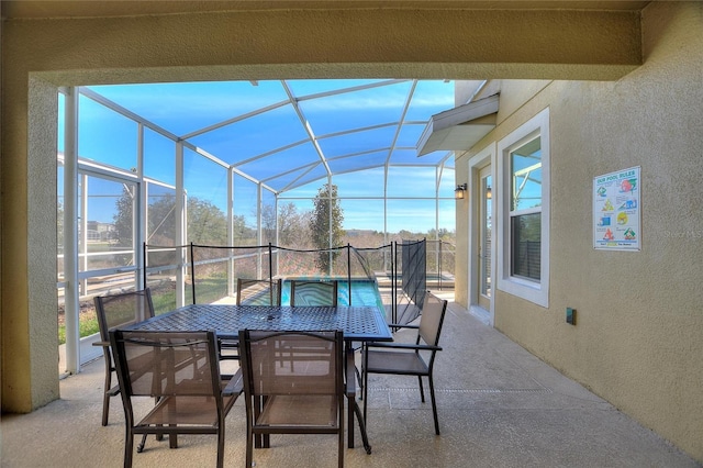 view of patio featuring a lanai