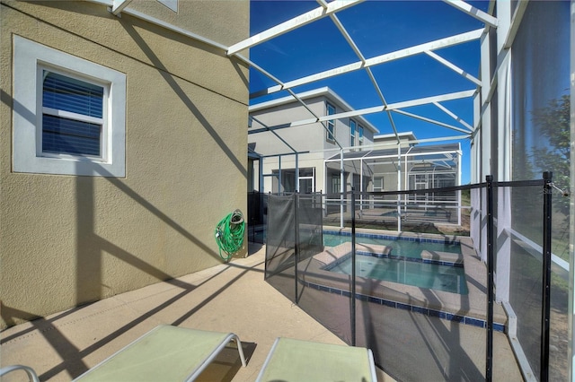 view of swimming pool with a lanai, an in ground hot tub, and a patio