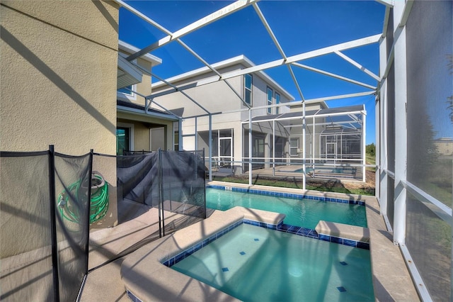 view of swimming pool featuring a lanai, an in ground hot tub, and a patio