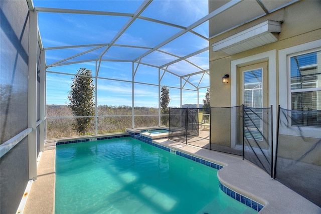 view of pool featuring a patio area, a lanai, and an in ground hot tub