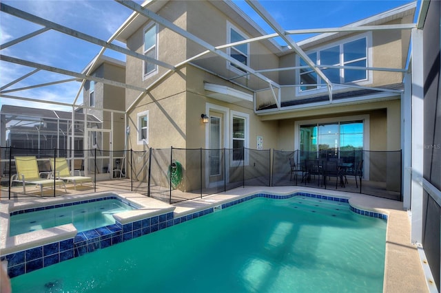 view of pool featuring an in ground hot tub, a patio area, and a lanai