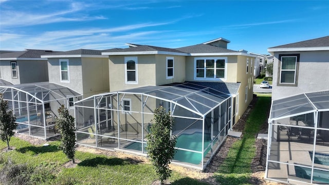 rear view of property with a lanai