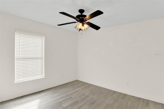 empty room featuring ceiling fan and light wood-type flooring