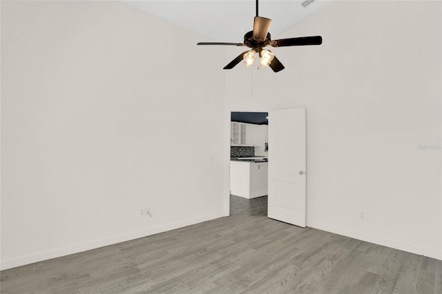 unfurnished room featuring light hardwood / wood-style floors, ceiling fan, and lofted ceiling