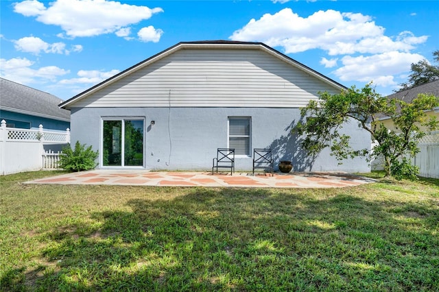 back of house with a yard and a patio area